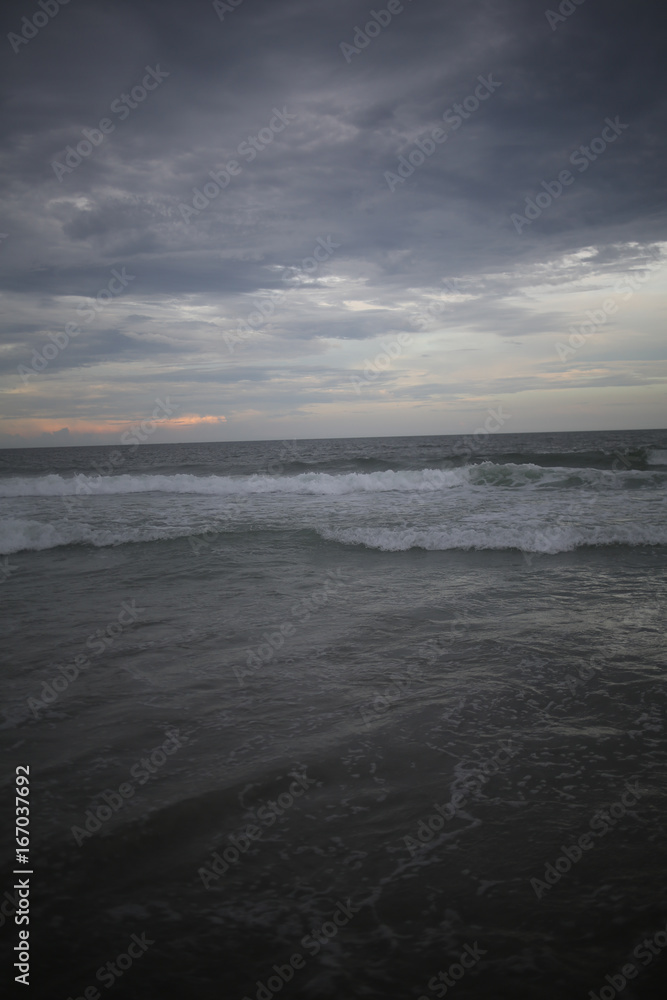 Ocean with Crashing Waves under a stormy sky at dusk
