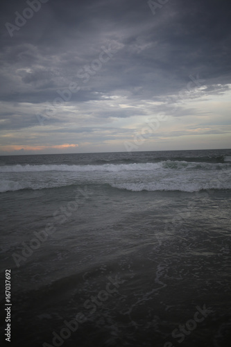 Ocean with Crashing Waves under a stormy sky at dusk