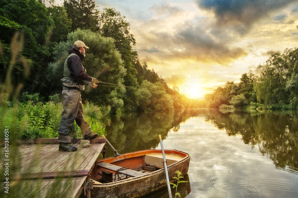 Photo & Art Print Sport fisherman hunting fish. Outdoor fishing in river