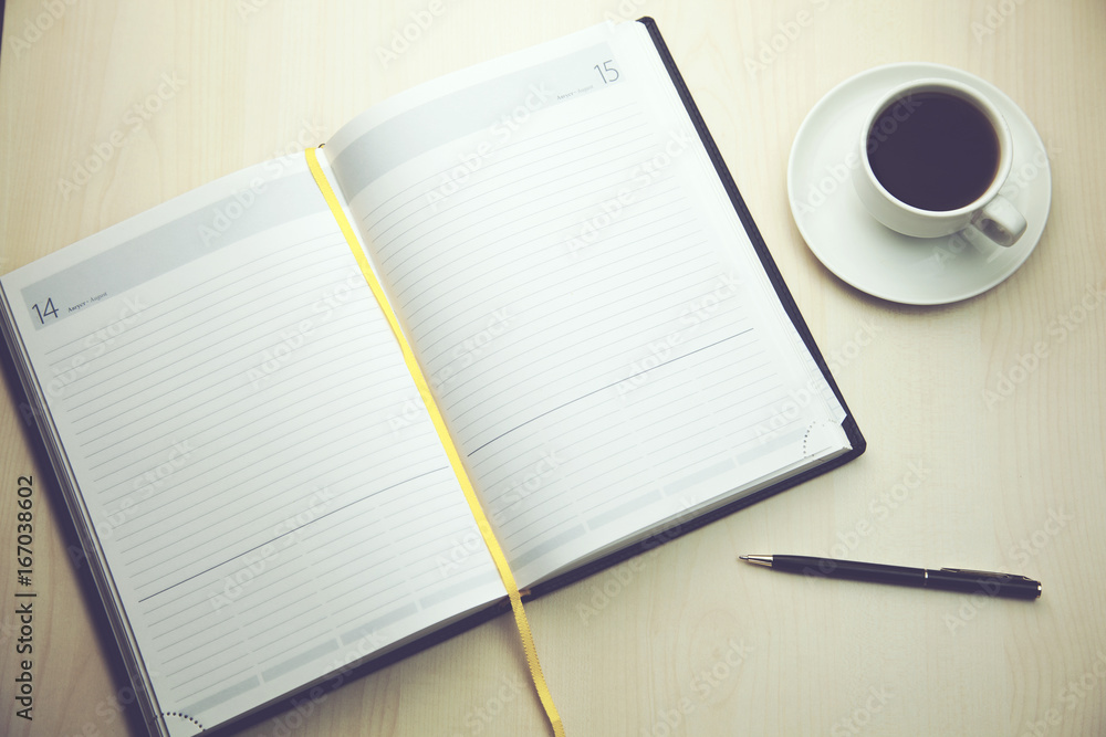 Notepad with cup of coffee Notepad with cup of coffee