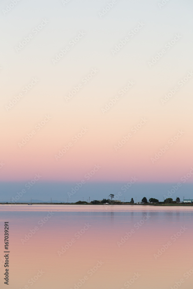 Pink sky at sunset over water