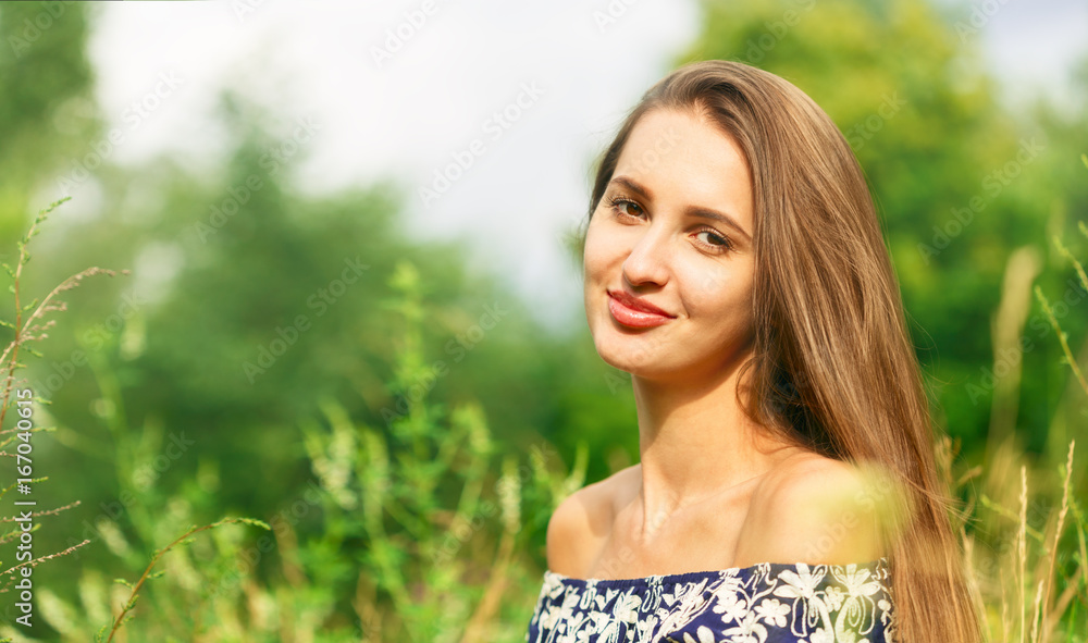 Woman smiling with perfect smile in a park and looking at camera Woman smiling with perfect smile in a park and looking at camera