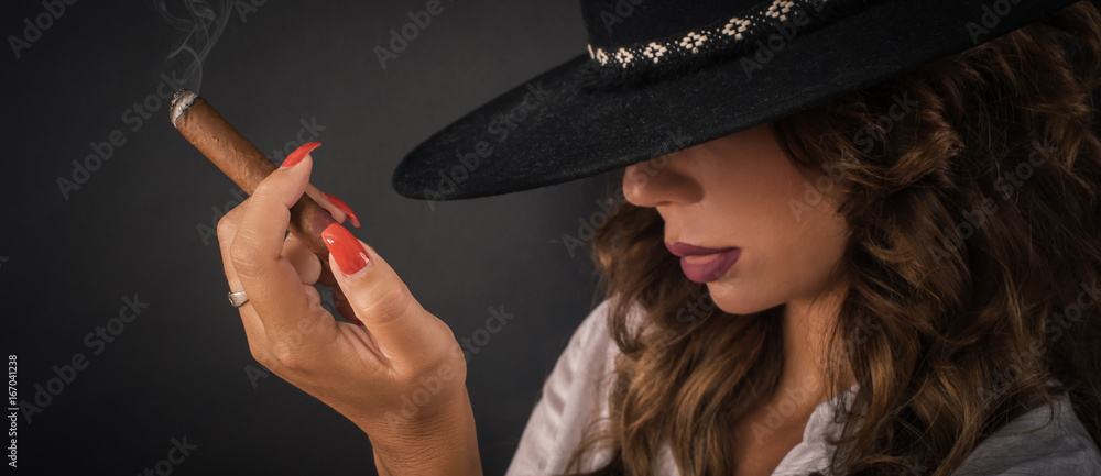 Portrait of sexy elegant lady woman with hat smoking cigar Portrait of sexy elegant lady woman with hat smoking cigar