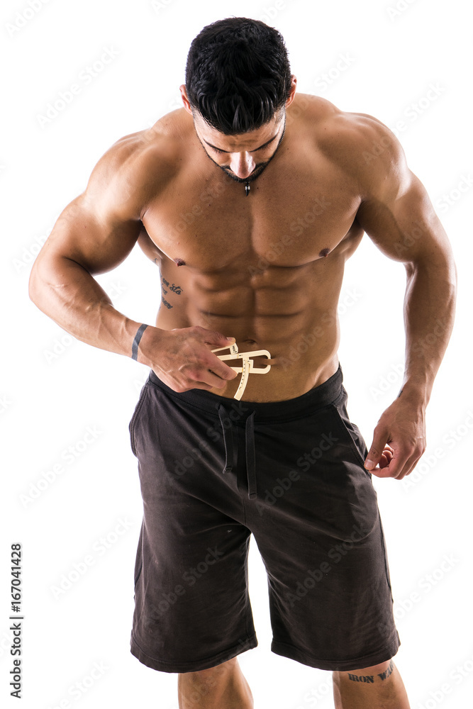 Handsome muscular and shirtless male using plicometer on white background. Handsome muscular and shirtless male using plicometer on white background.