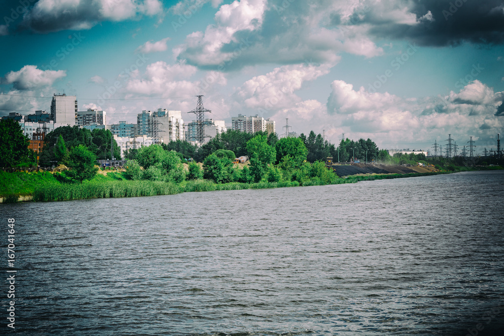 A large multi-storey building on the outskirts of the city. View from the Moscow River
