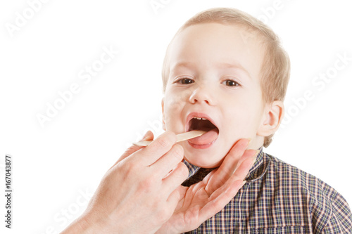 Pediatrician examining little child, tonsils