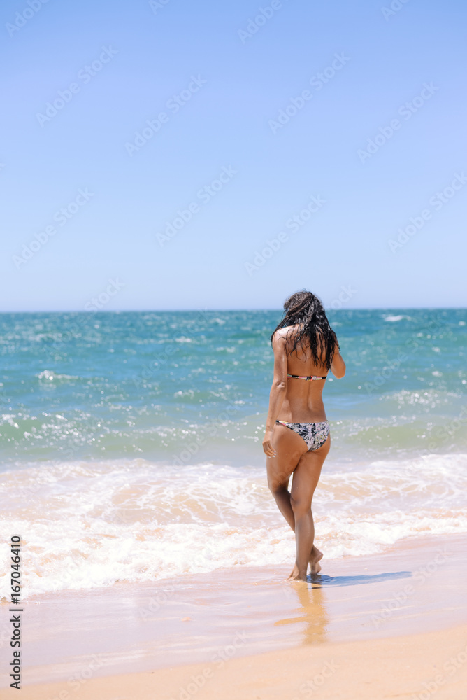 Attractive woman bathing playfully on a sunny summer holiday, joyful, coastal outdoors background. Travel lifestyle enjoying the sun on beach shore. Attractive woman bathing playfully on a sunny summer holiday, joyful, coastal outdoors background. Travel lifestyle enjoying the sun on beach shore.