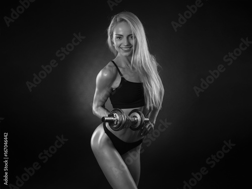 beautiful sports girl with dumbbells