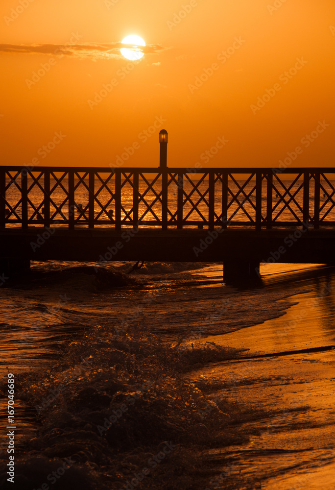 Sunset over the sea. Pier on the foreground. Panorama Sunset over the sea. Pier on the foreground. Panorama