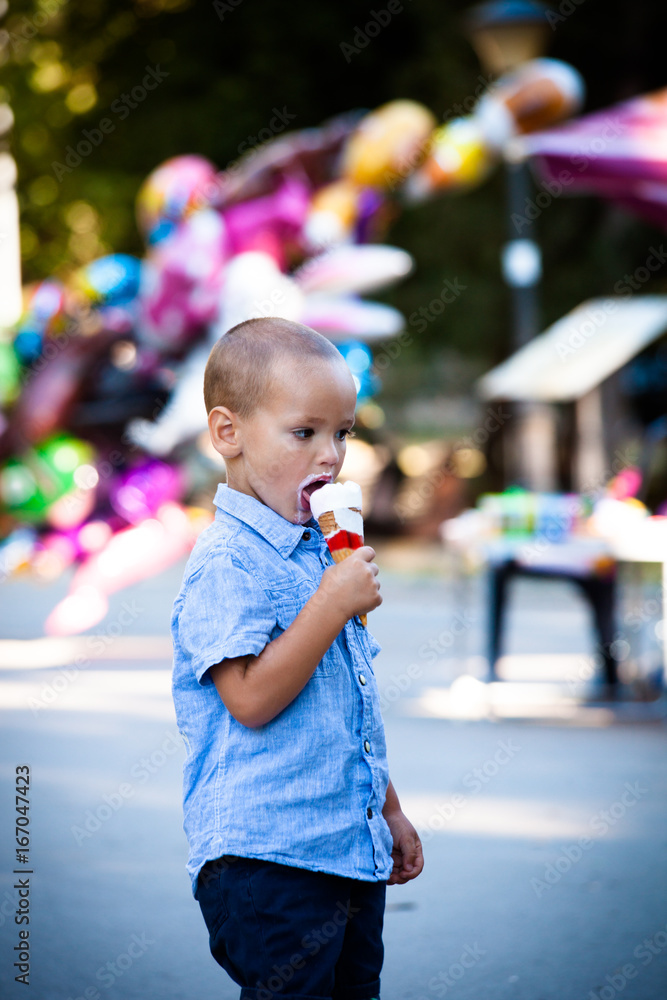 ittle boy eating ice cream in park summer day ittle boy eating ice cream in park summer day