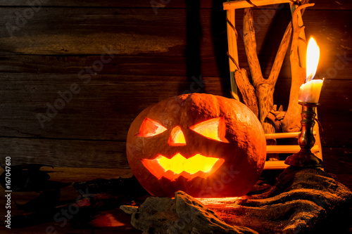 Candlestick with pumpkins on wooden background with copy space