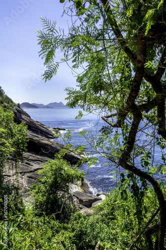 Walking on the Claudio Coutinho track beside the sea and rocks