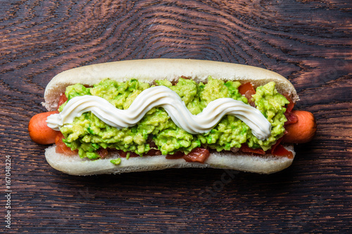 Chilean Completo Italiano. Hot dog sandwiches with tomato, avocado and mayonnaise on wooden board. Top view, copy space