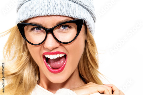 Happy young woman in winter clothes on a white background