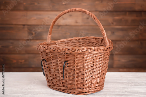 Bicycle wicker basket on wooden table