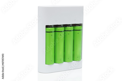 Green rechargeable aa battery in a charger - using  environmentally friendly product concept © weerapat1003