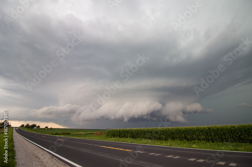 A low wall cloud hangs under the base of a large supercell thunderstorm in Iowa.