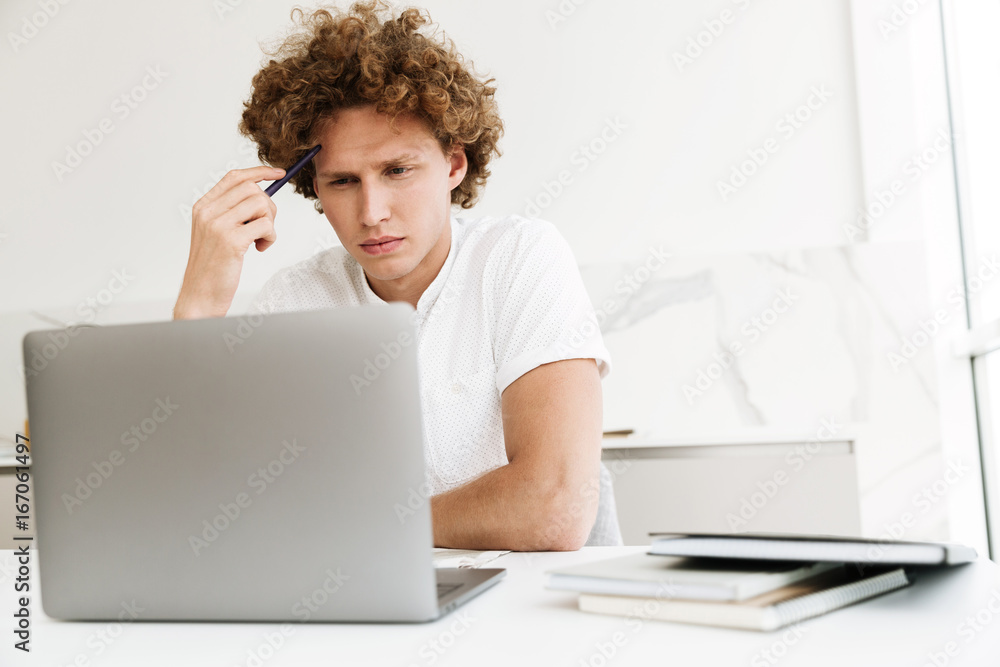 Handsome concentrated serious man using laptop computer. Handsome concentrated serious man using laptop computer.