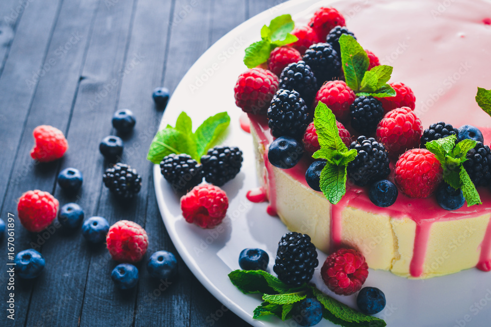 Cake with butter and fresh berries and fruits. Dessert. On a wooden background. Top view. Free space for your text. Cake with butter and fresh berries and fruits. Dessert. On a wooden background. Top view. Free space for your text.