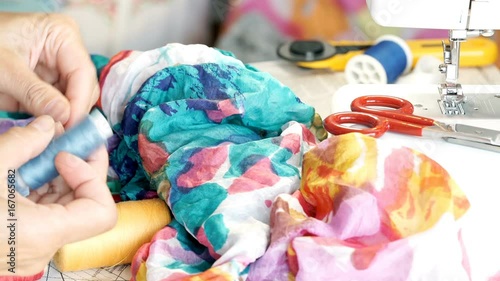 Wallpaper Mural Seamstress holding colorful fabric and tries to match the thread
 Torontodigital.ca