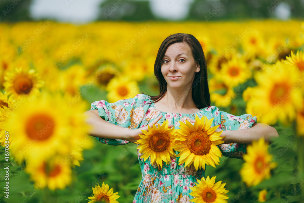 Girl applies sunflower flowers to her breast Girl applies sunflower flowers to her breast