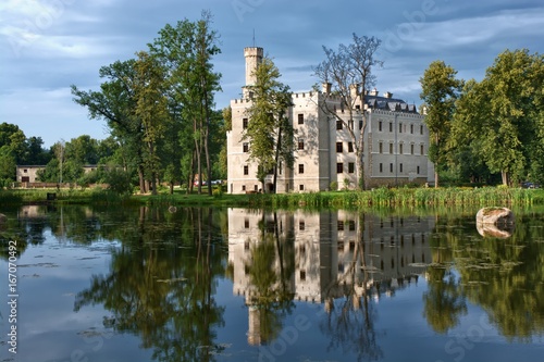 Neo-Gothic style castle surrounded by an English landscape garden in Karpniki, Poland photo