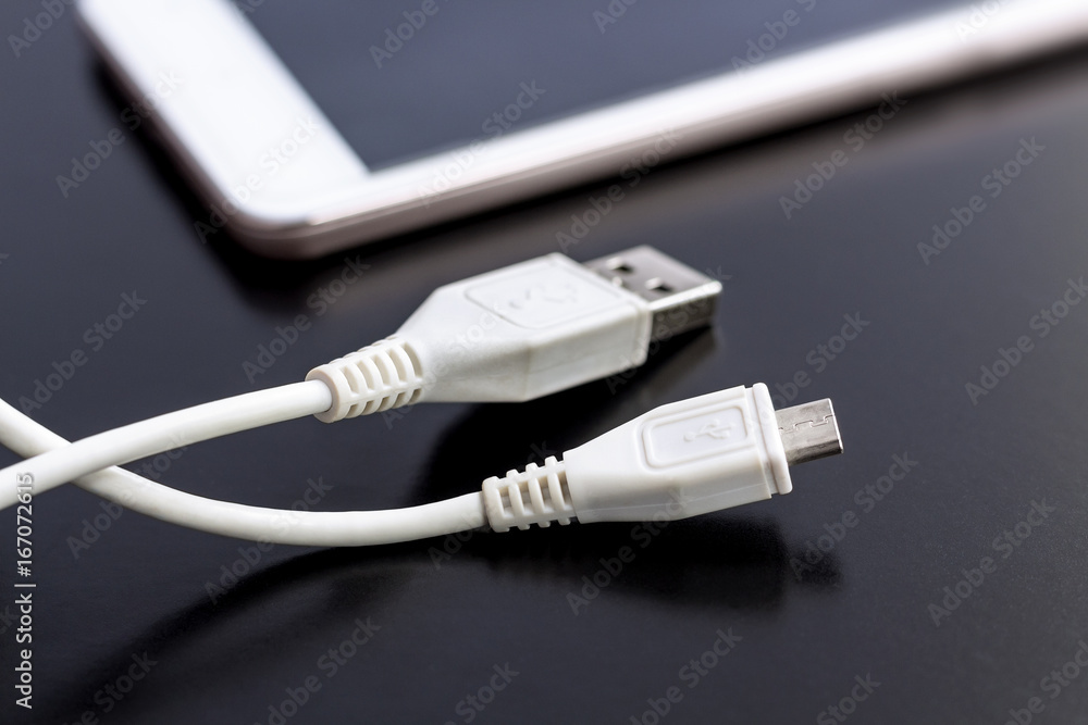 Charger cable for mobile phone on black background. Charger cable for mobile phone on black background.