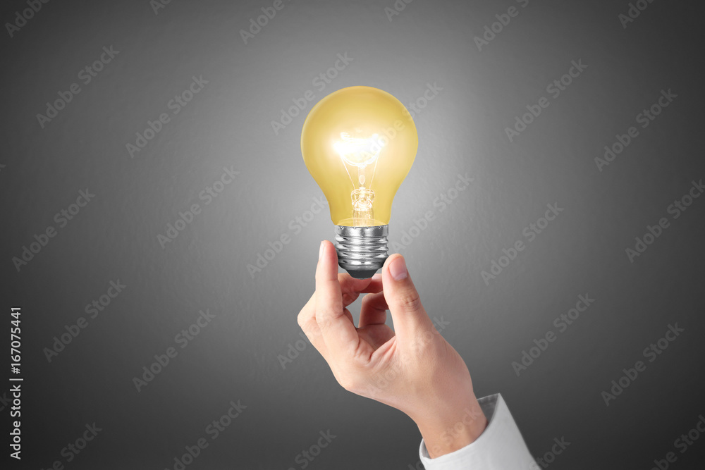 hand holding light bulb with energy hand holding light bulb with energy