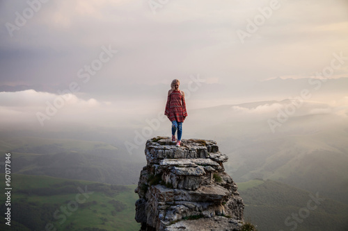 Young woman on the cliff photo