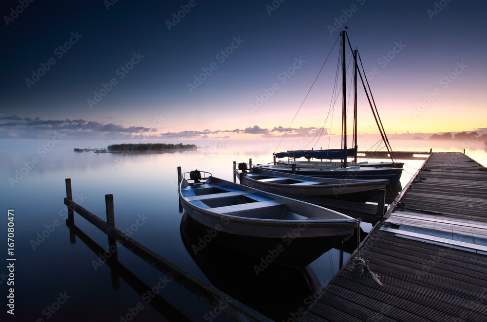Fototapeta premium misty sunrise on lake harbor