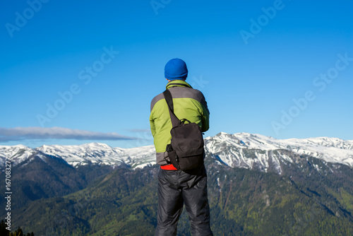 Traveler photographer stands in a mountains