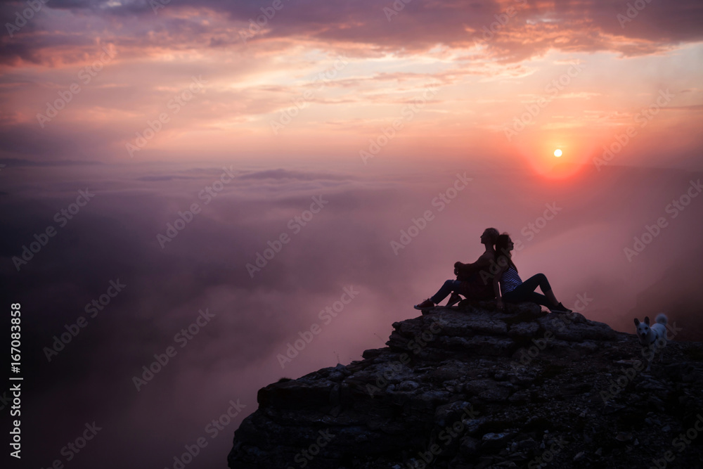 Young woman on the cliff and enjoying sunset Young woman on the cliff and enjoying sunset