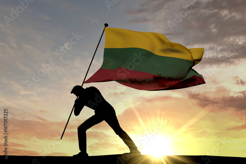 Lithuania flag being pushed into the ground by a male silhouette. 3D Rendering