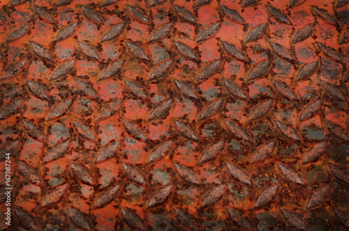 Rusted sheet of metal, old aluminium floor or diamond plate metal background with grunge rusty effect.