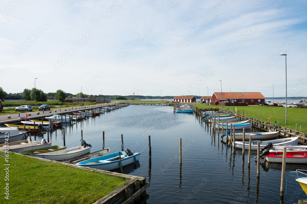 Denmark, Northern Jutland, Nibe. The towns marina/harbor with typical red wooden danish buildings and ships.