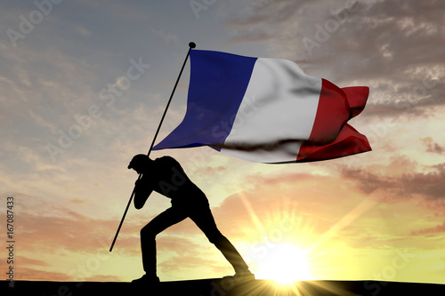France flag being pushed into the ground by a male silhouette. 3D Rendering