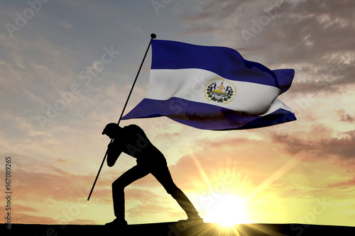 El Salavdor flag being pushed into the ground by a male silhouette. 3D Rendering