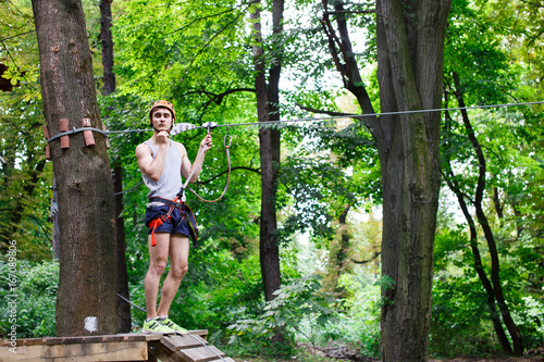 Man prepares to climb on the ropes in the park