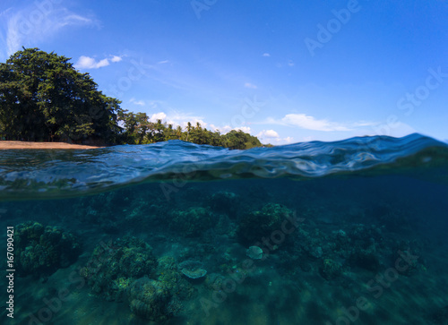 Double landscape with sea and sky. Sea panorama split photo. Undersea view of tropical island seashore.