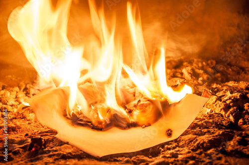 A white sheet of paper destroying in the flame