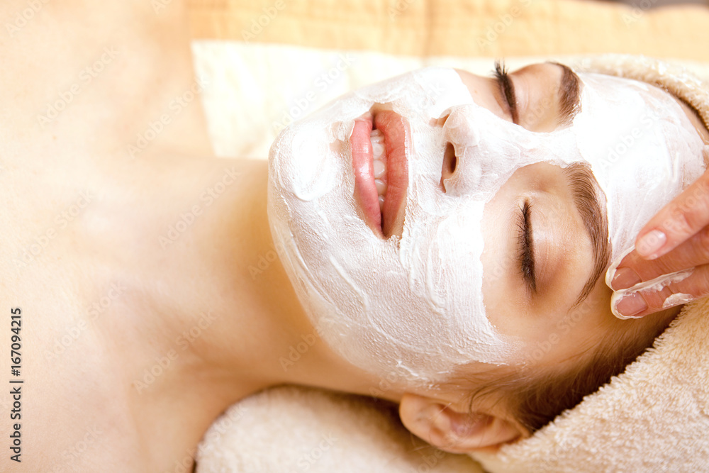 Fototapeta premium Spa salon: Beautiful Young Woman having Facial Mask