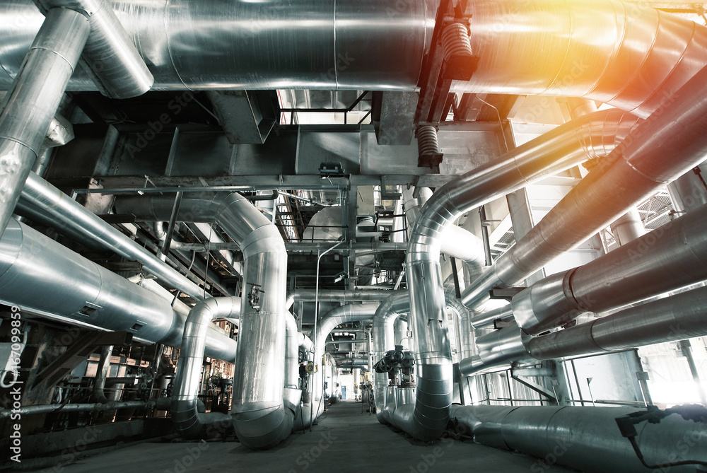 Fototapeta premium Equipment, cables and piping as found inside of a modern industrial power plant