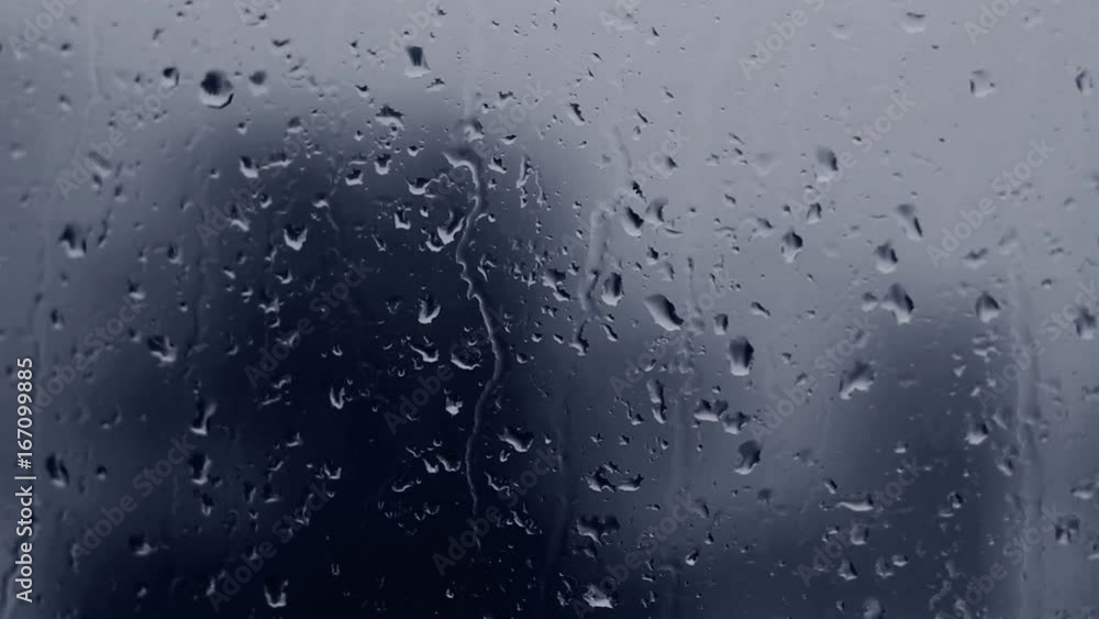 Dark blue rain drops on window glass. Dark blue rain drops on window glass.