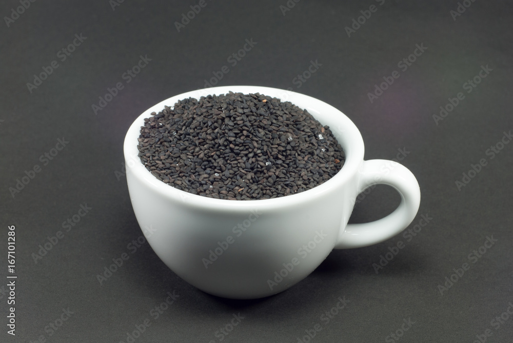 Black sesame in white cup with black background