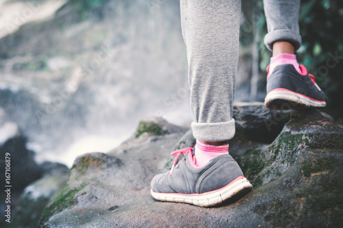 Feet of hipster girl walking in waterfall background, Relax time on holiday