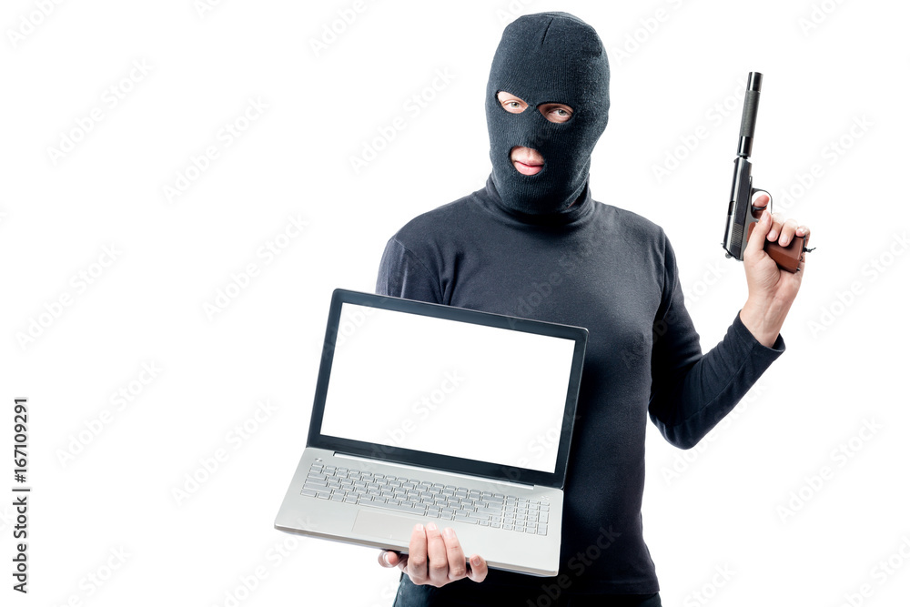 The criminal with the weapon holds a laptop, space for writing on the screen The criminal with the weapon holds a laptop, space for writing on the screen
