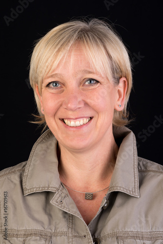 beautiful caucasian mature woman in khaki shirt  - photograph on black background