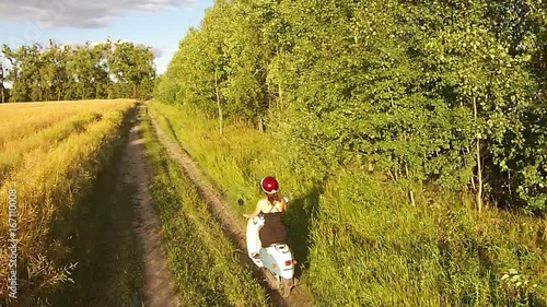 Wallpaper Mural A girl riding a scooter on a country road Torontodigital.ca