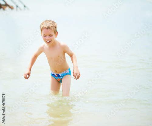 Cheerful boy in the water of the black sea