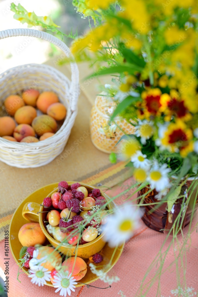 Cup of berries and bouquet of wildflowers Cup of berries and bouquet of wildflowers